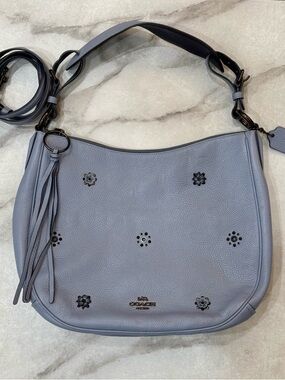 Coach Light Blue-Gray Pebble Leather Shoulder Hobo with Floral Stud Accents.